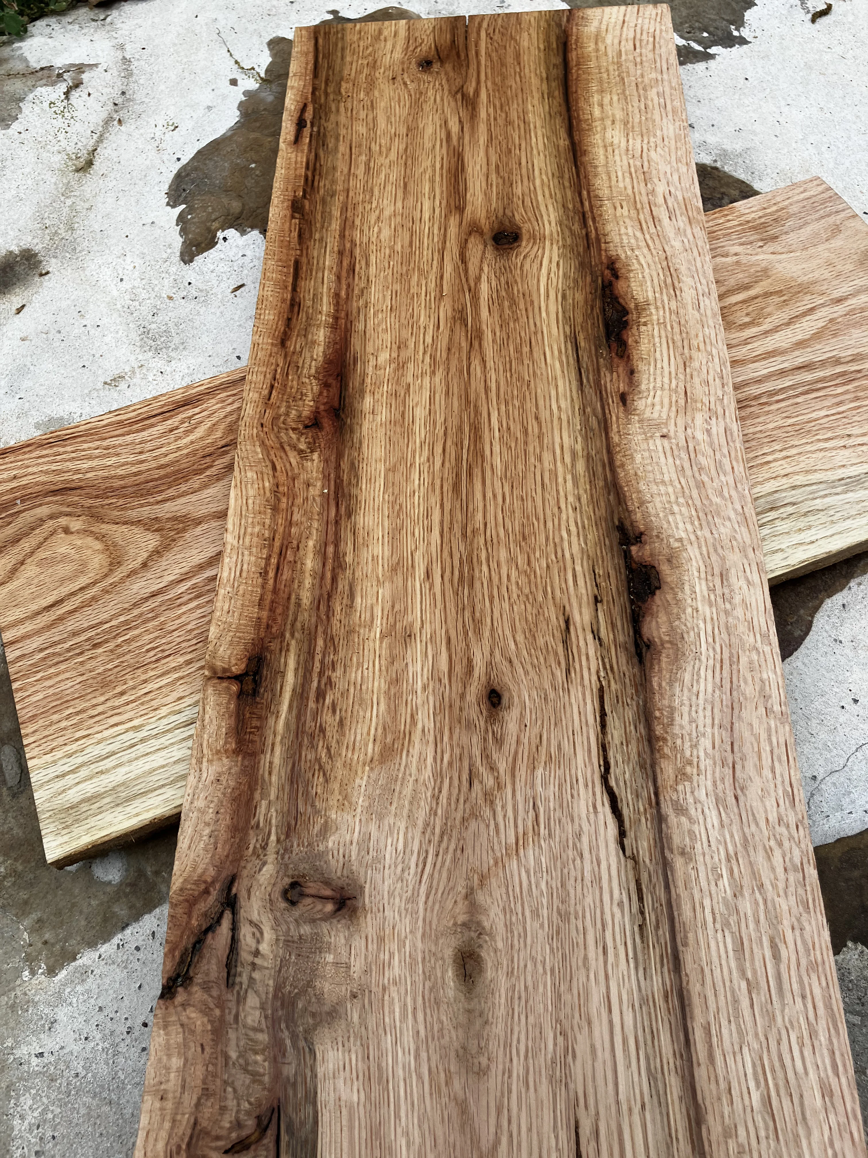 Black oak wood grain — deep chocolate-brown tones with dramatic grain figure, harvested in Tennessee